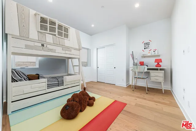 a bedroom with bed and painting on the wall