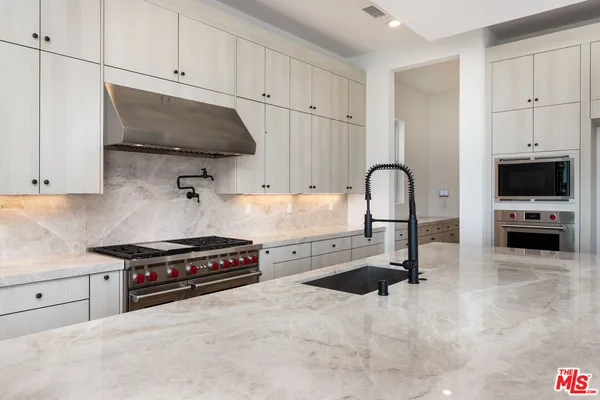 a white stove top oven sitting inside of a kitchen