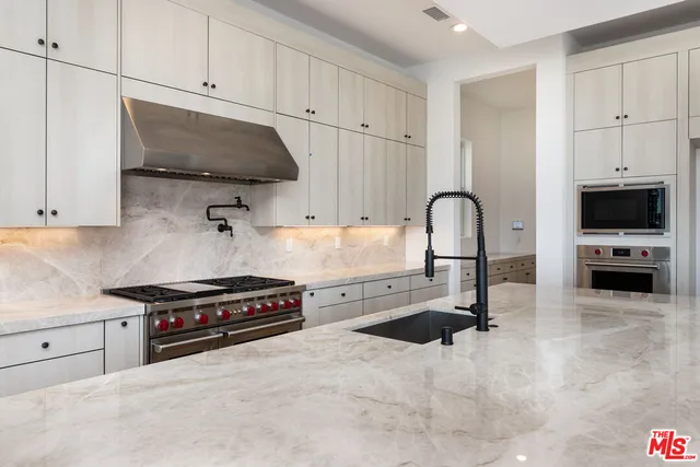 a white stove top oven sitting inside of a kitchen