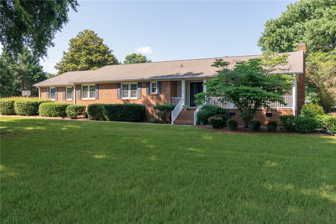 3513 Hopewell Road Anderson, SC 29621 - Photo 46 of 50 A well-maintained lawn welcomes you to this classic brick home, featuring a covered front porch and mature landscaping.