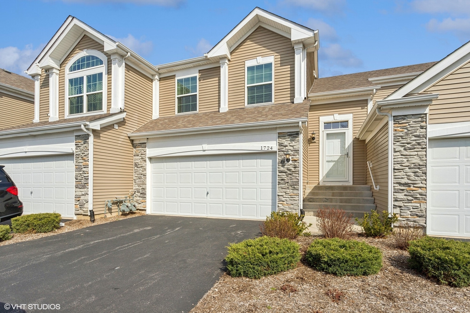 1724 Fredericksburg Lane Aurora, IL 60503 - Photo 2 of 20 a front view of a house with a yard and garage