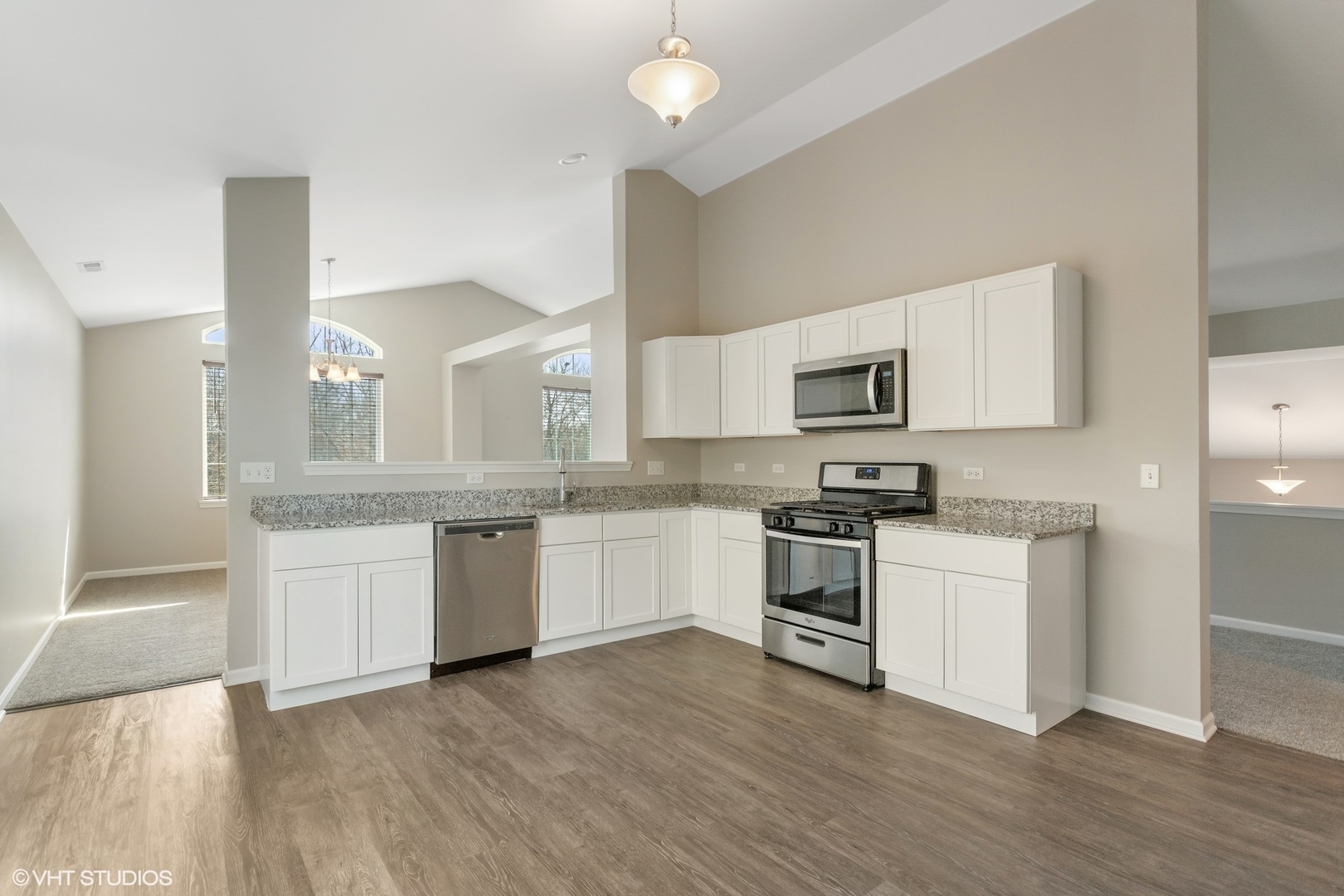 1724 Fredericksburg Lane Aurora, IL 60503 - Photo 7 of 20 a kitchen with granite countertop white cabinets and stainless steel appliances