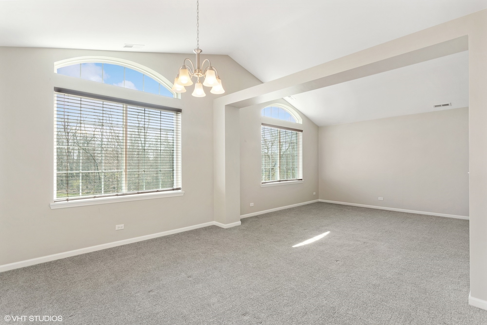 1724 Fredericksburg Lane Aurora, IL 60503 - Photo 9 of 20 an empty room with chandelier and windows