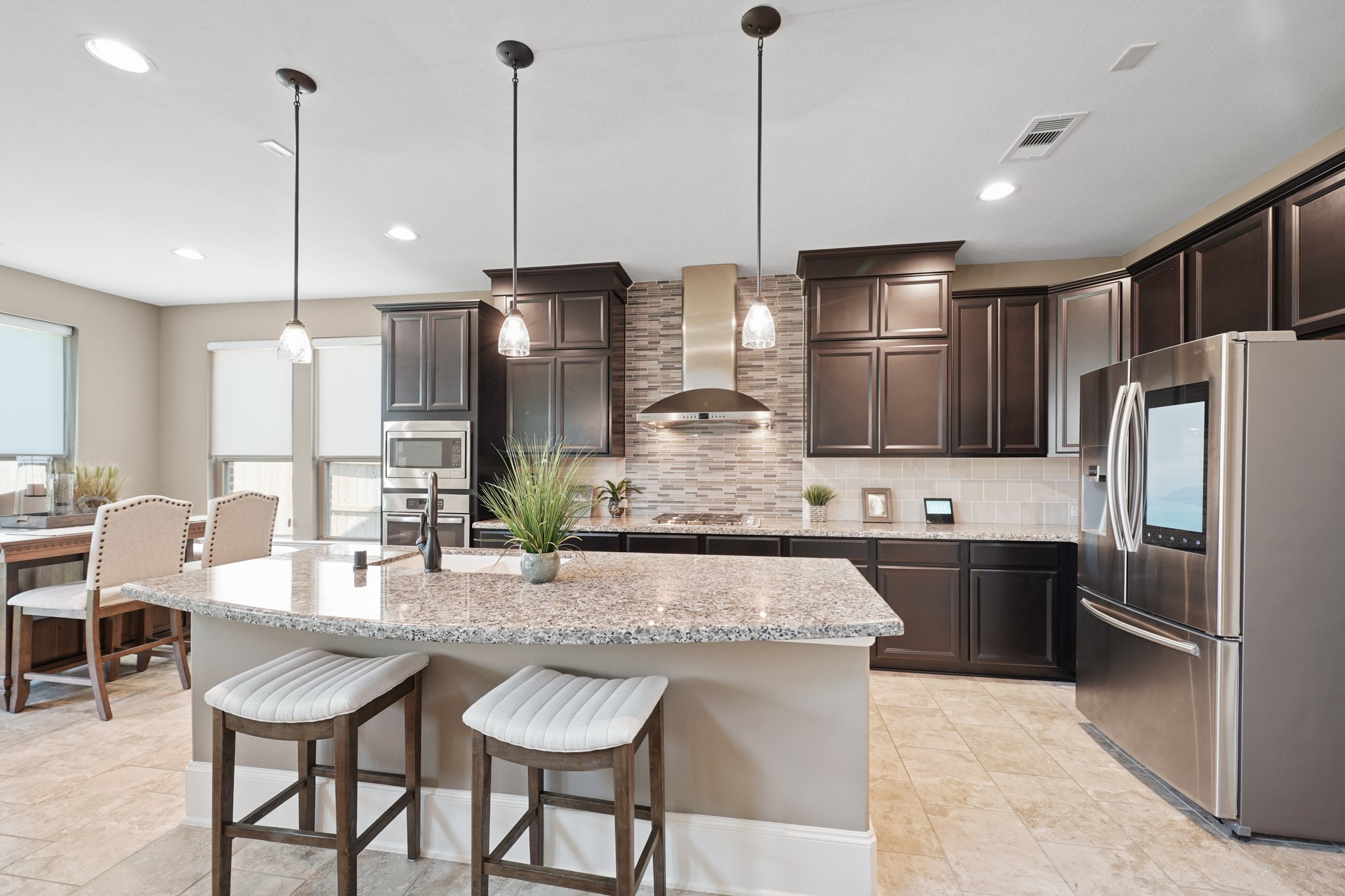 4210 Dalea Clover Lane Manvel, TX 77578 - Photo 10 of 38 a kitchen with refrigerator a island and chairs