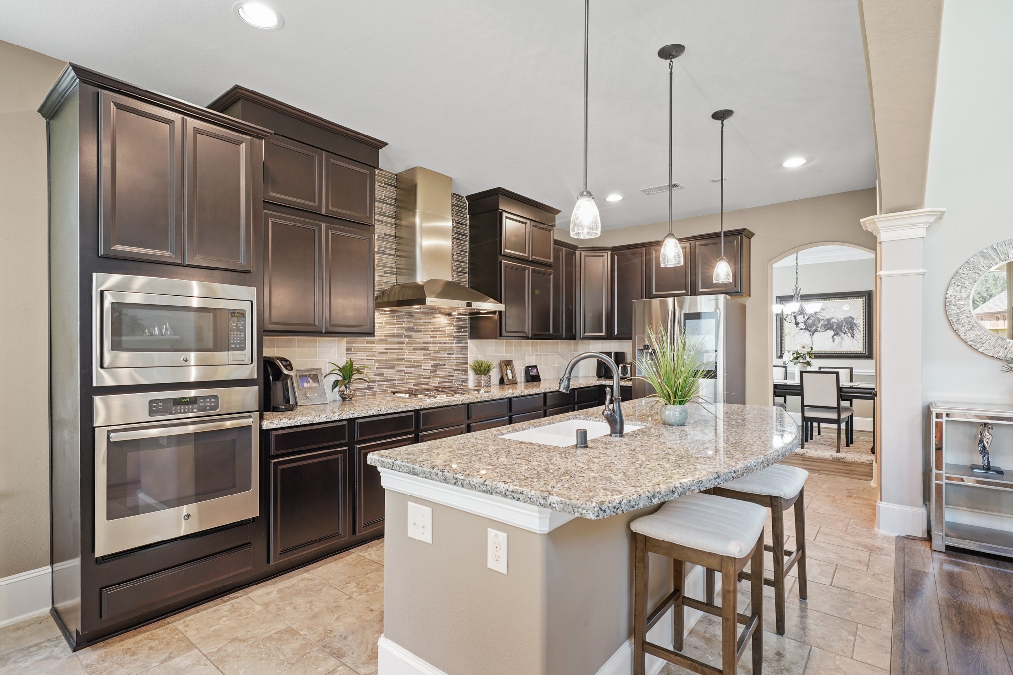 4210 Dalea Clover Lane Manvel, TX 77578 - Photo 11 of 38 a kitchen with stainless steel appliances granite countertop a stove a sink and a refrigerator