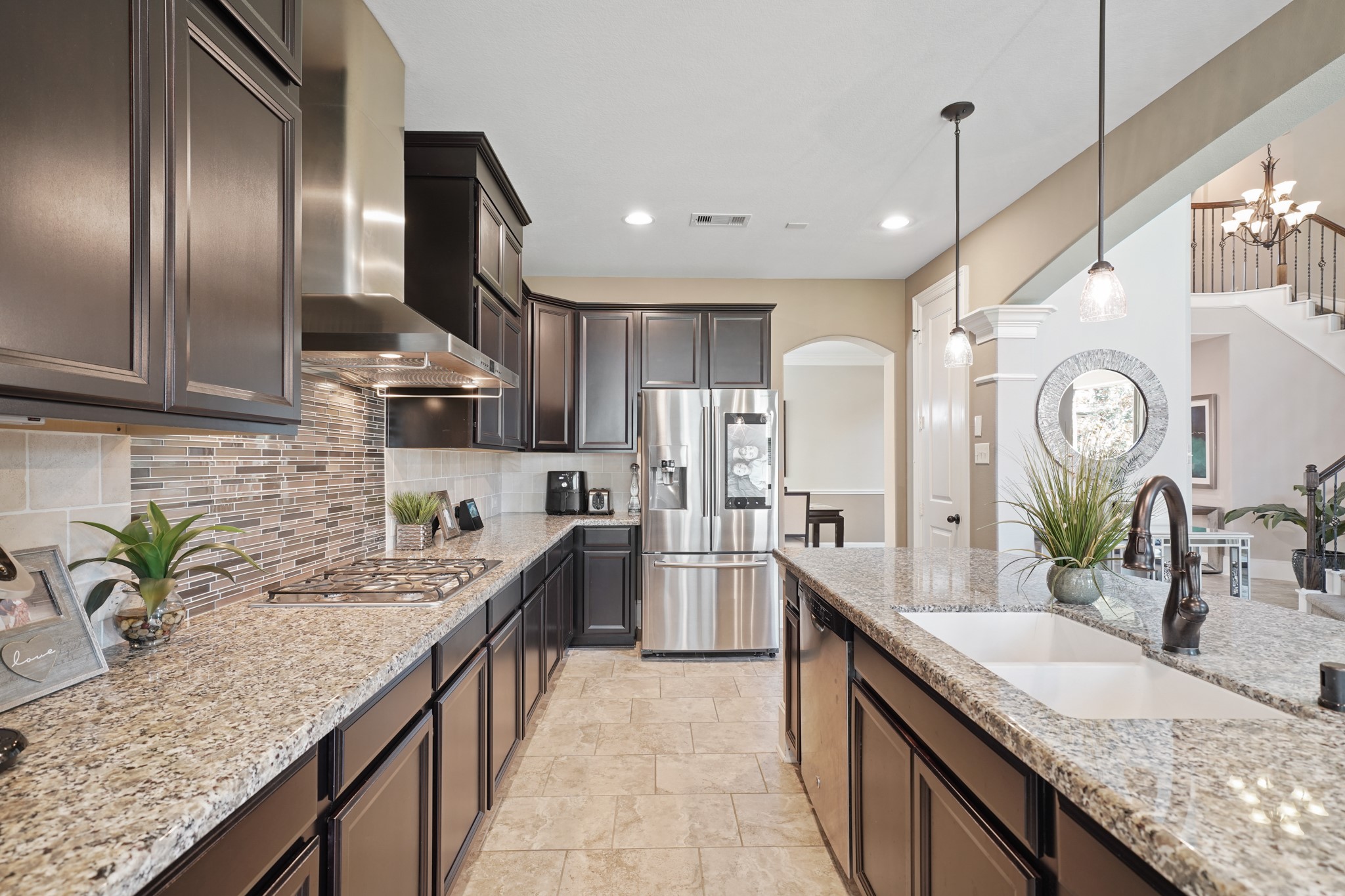 4210 Dalea Clover Lane Manvel, TX 77578 - Photo 12 of 38 a large kitchen with granite countertop a sink a counter space appliances and cabinets