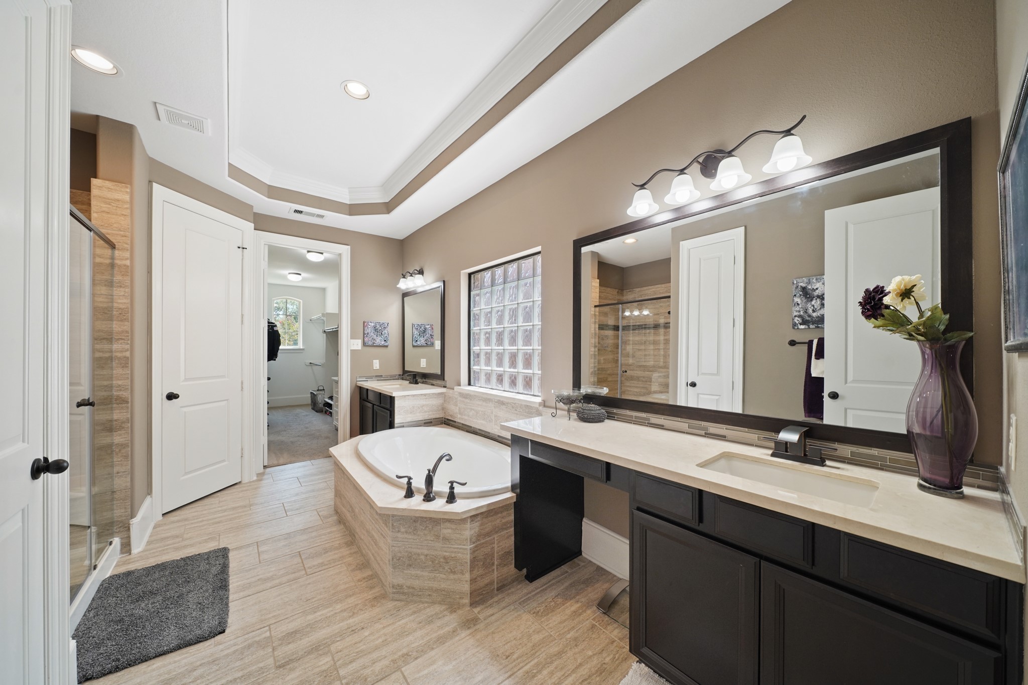 4210 Dalea Clover Lane Manvel, TX 77578 - Photo 15 of 38 a spacious bathroom with a double vanity sink a mirror and a bathtub