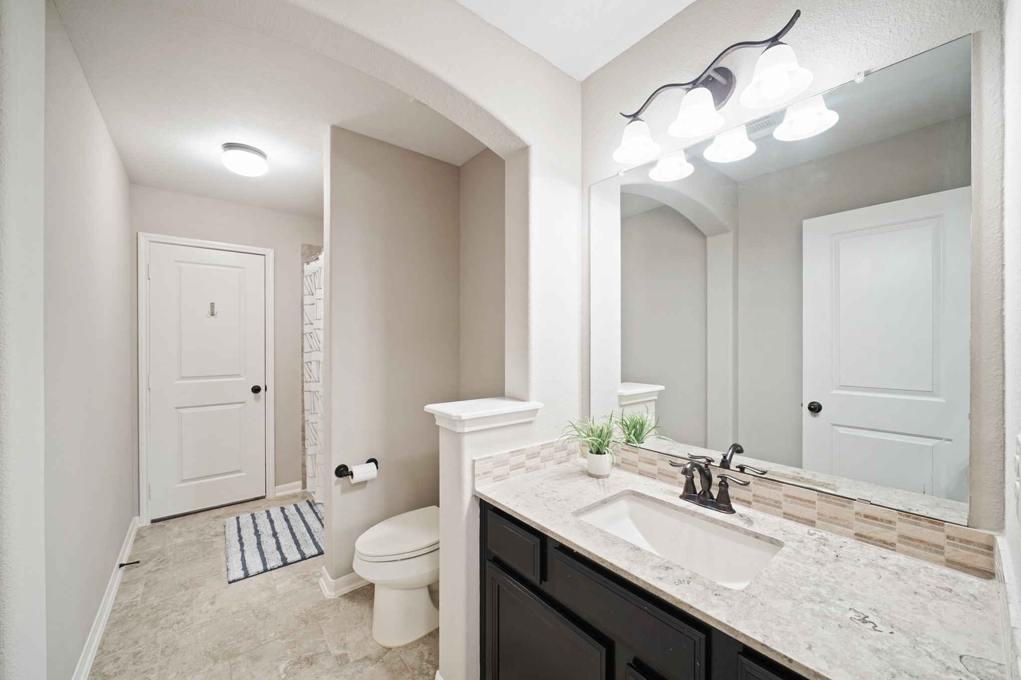 4210 Dalea Clover Lane Manvel, TX 77578 - Photo 23 of 38 a bathroom with a granite countertop sink a toilet and a mirror