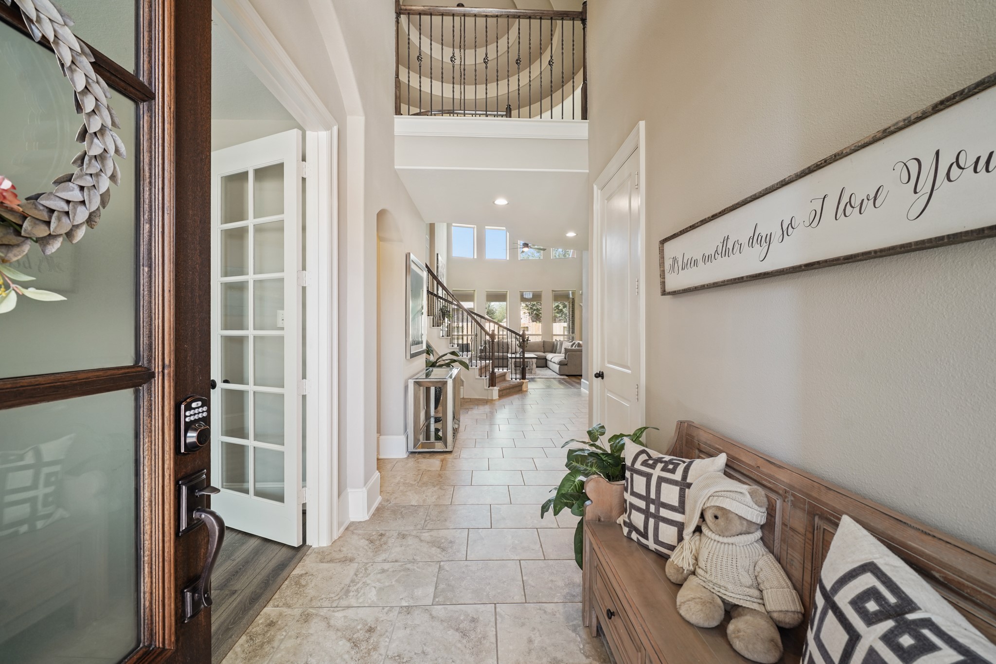 4210 Dalea Clover Lane Manvel, TX 77578 - Photo 3 of 38 a hallway with a dining table and a chandelier