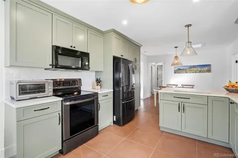 a kitchen with stainless steel appliances a stove sink microwave and refrigerator