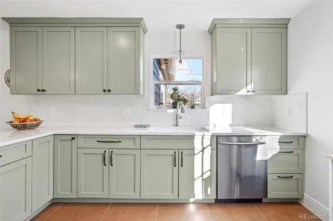 a kitchen with a sink cabinets and wooden floor