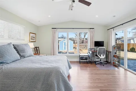 a bed room with furniture and a large window