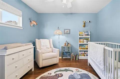 a living room with furniture and a baby crib