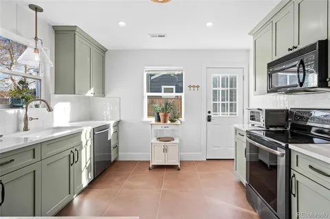 a kitchen with stainless steel appliances granite countertop a stove and a sink