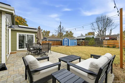 a view of a patio with couches chairs and wooden floor