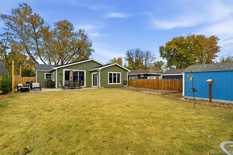 a front view of a house with a large tree