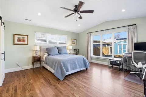 a bedroom with a bed and wooden floor