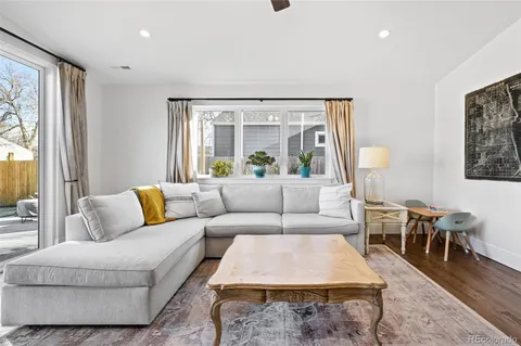 a living room with furniture potted plant and a large window
