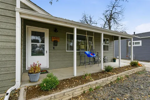 a view of a house with chair and potted plants