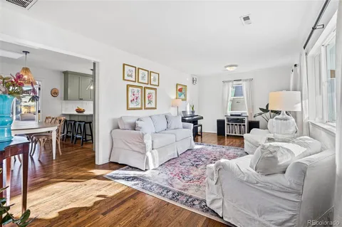 a living room with furniture a dining table and a piano table
