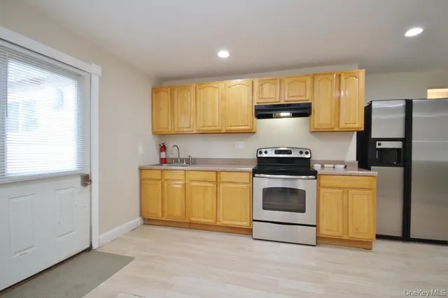 a kitchen with a stove a sink and a refrigerator