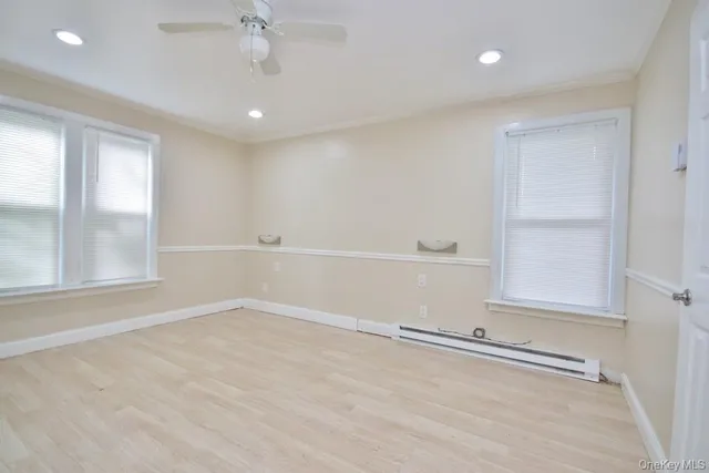 wooden floor in an empty room with a window