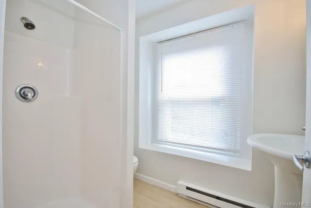 a bathroom with a bathtub and a window