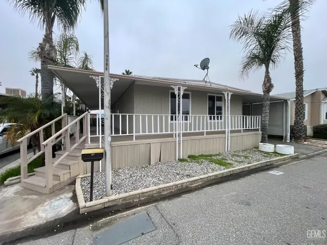 a front view of a house with plants