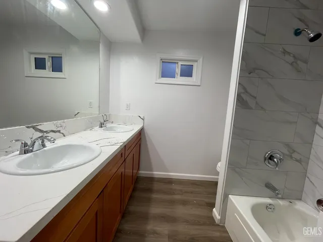 a bathroom with a double vanity sink and a bathtub