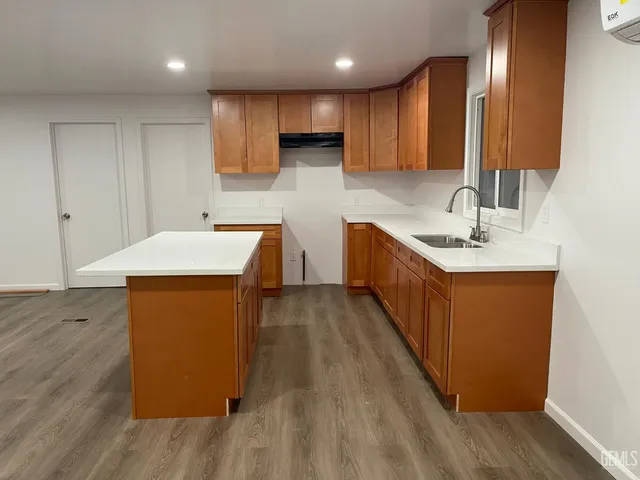 a kitchen with stainless steel appliances a sink stove and cabinets