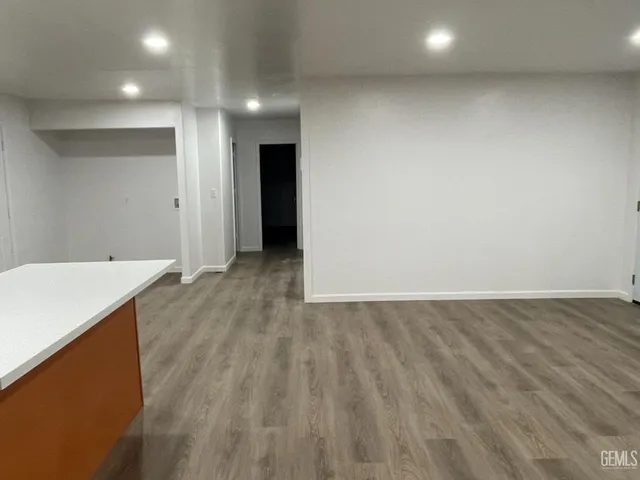 an empty room with wooden floor