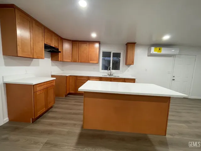 a kitchen with stainless steel appliances granite countertop wooden cabinets and sink