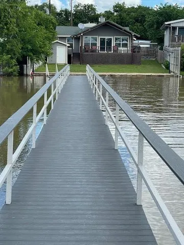 a view of a house with wooden floor next to a lake