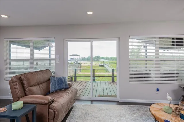 a living room with furniture and a floor to ceiling window
