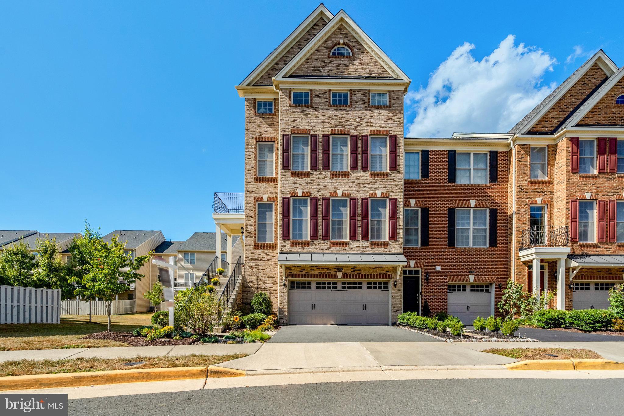 42634 Lancaster Ridge Terrace Chantilly, VA 20152 - Photo 1 of 63 front view of a building with a garden