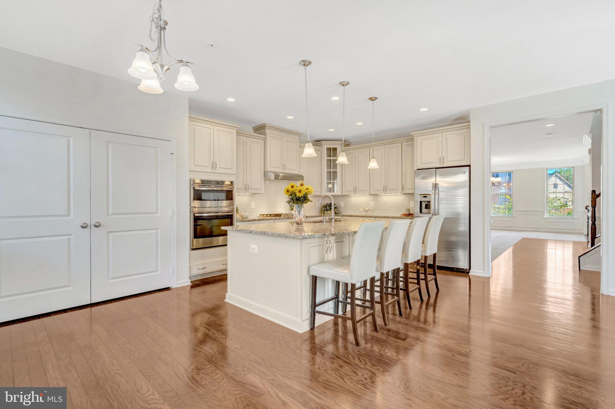 42634 Lancaster Ridge Terrace Chantilly, VA 20152 - Photo 18 of 63 a view of a dining room with furniture and wooden floor