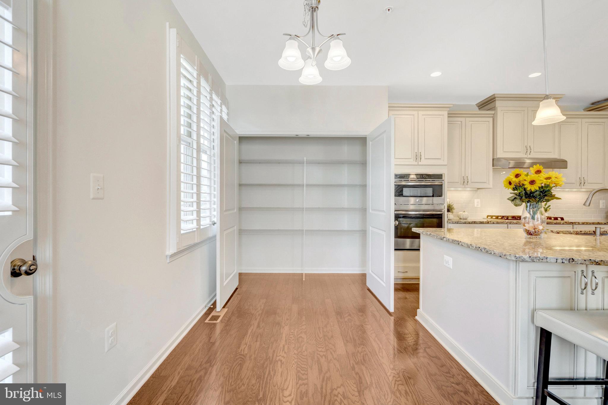 42634 Lancaster Ridge Terrace Chantilly, VA 20152 - Photo 20 of 63 a view of kitchen with wooden floor and window