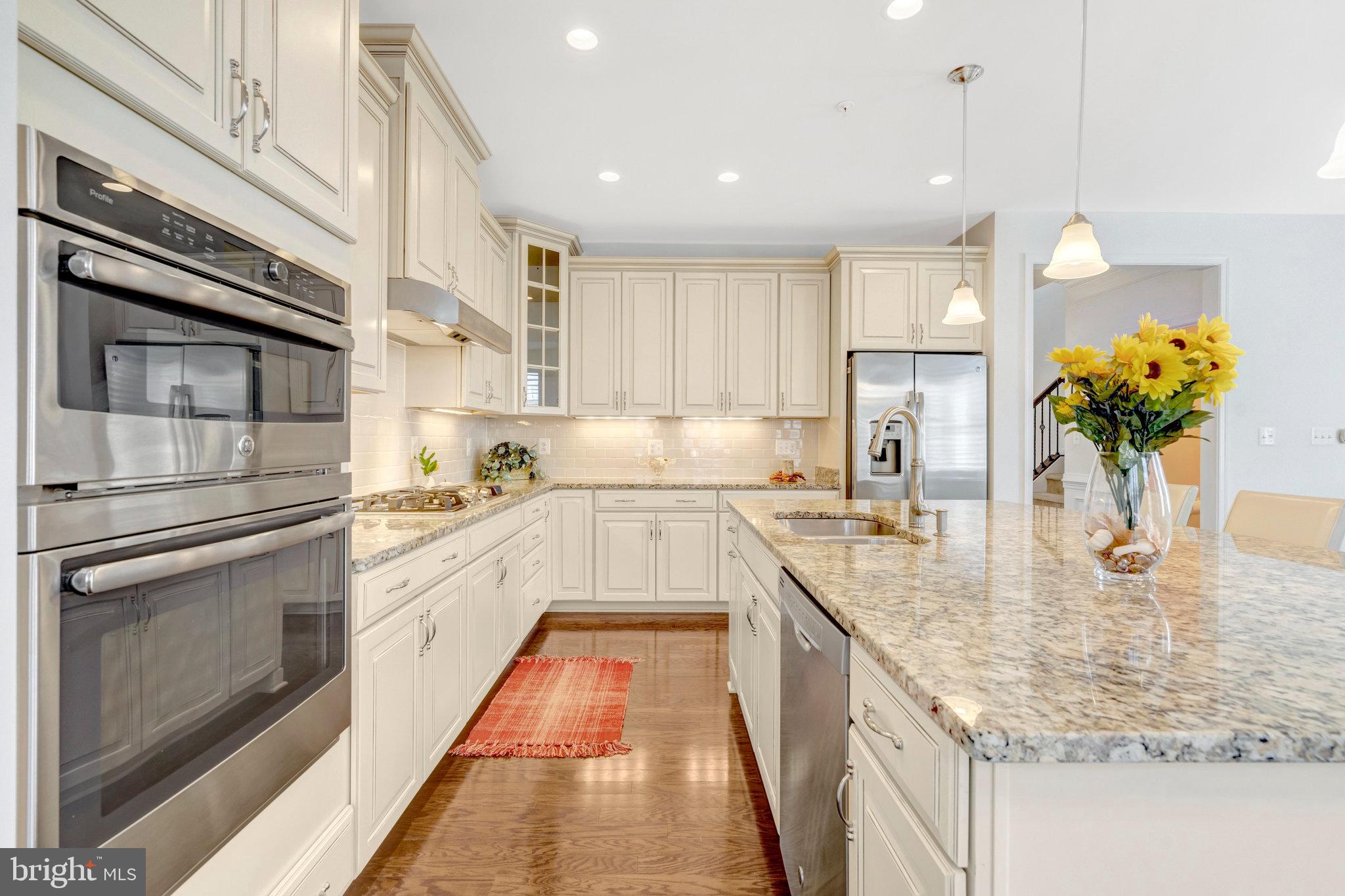 42634 Lancaster Ridge Terrace Chantilly, VA 20152 - Photo 21 of 63 a kitchen with stainless steel appliances granite countertop a sink a stove and cabinets