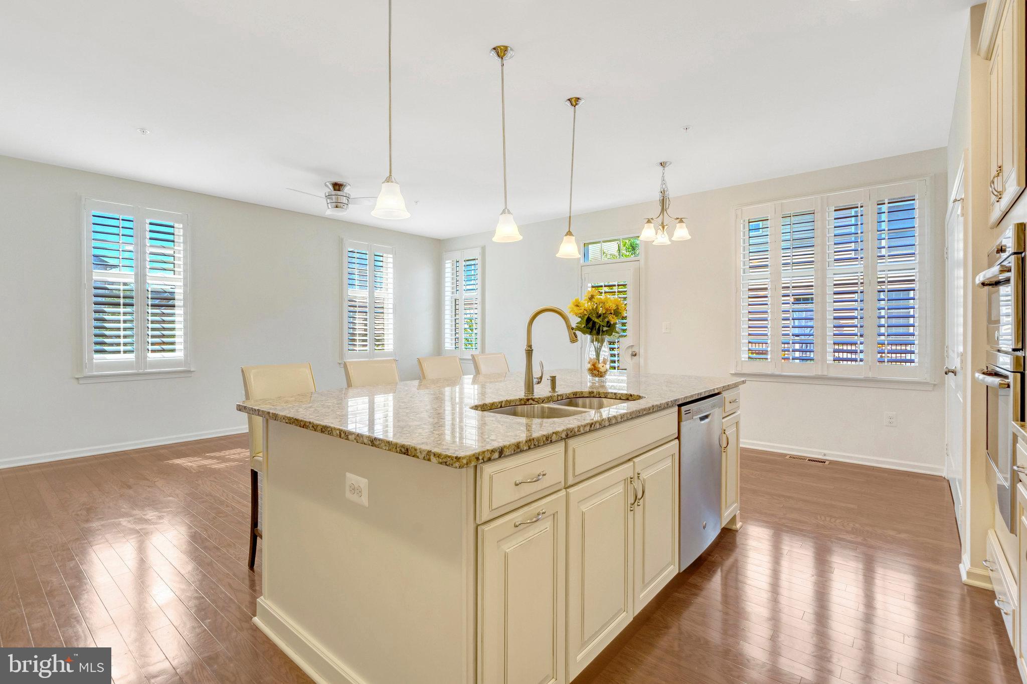 42634 Lancaster Ridge Terrace Chantilly, VA 20152 - Photo 22 of 63 a kitchen with kitchen island a counter top space a sink a window and stainless steel appliances