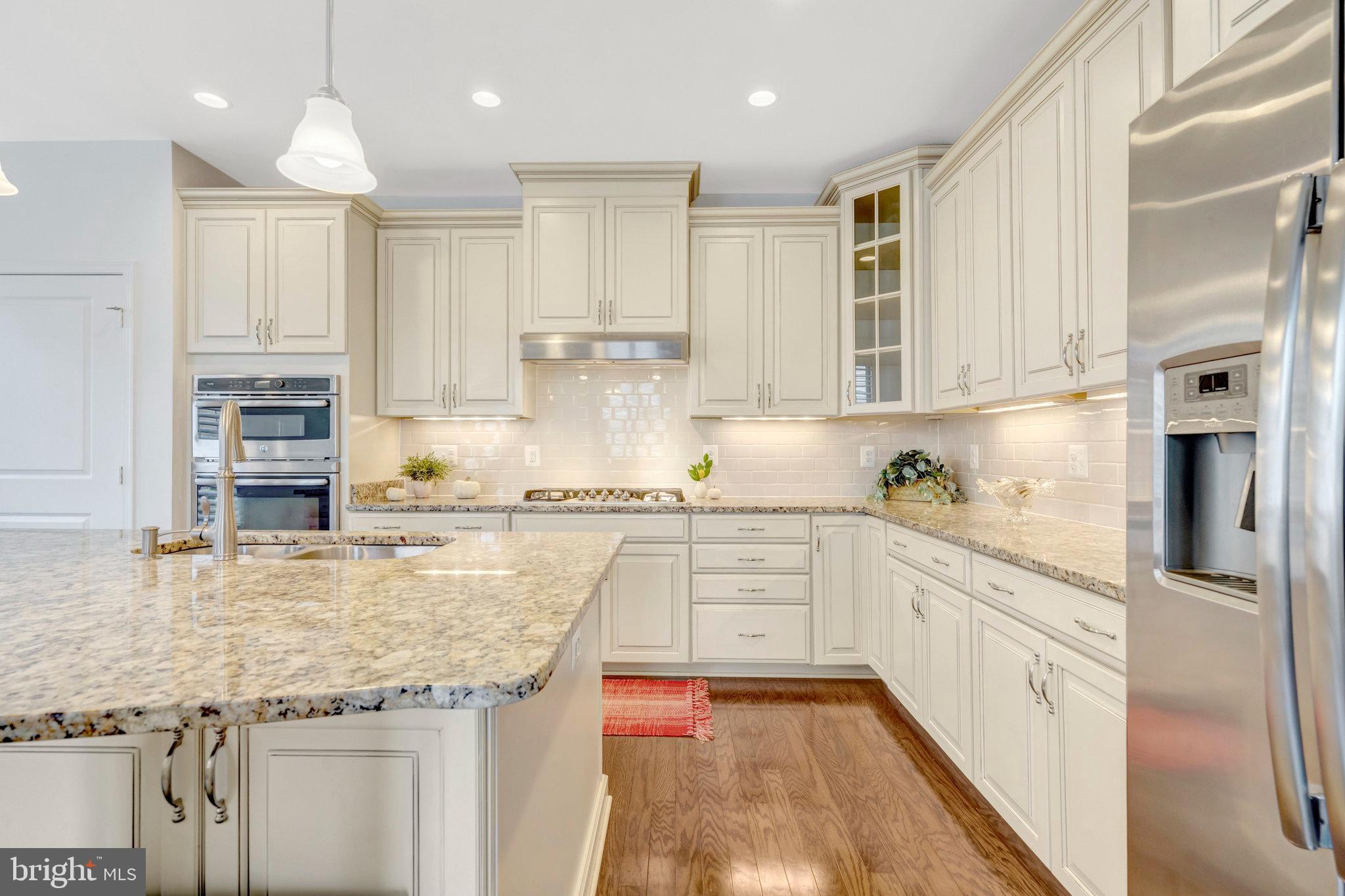 42634 Lancaster Ridge Terrace Chantilly, VA 20152 - Photo 23 of 63 a kitchen with granite countertop a sink stove and cabinets