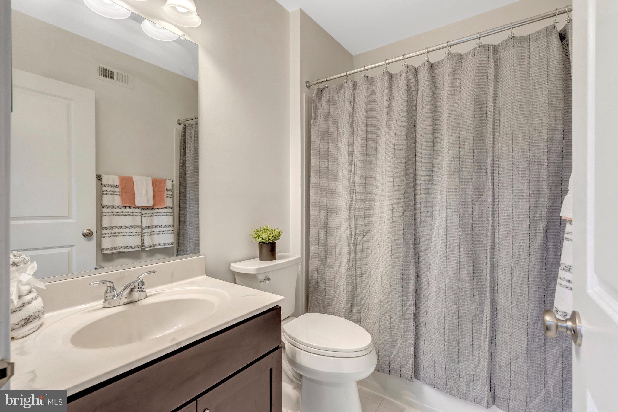 42634 Lancaster Ridge Terrace Chantilly, VA 20152 - Photo 31 of 63 a bathroom with a sink toilet and mirror