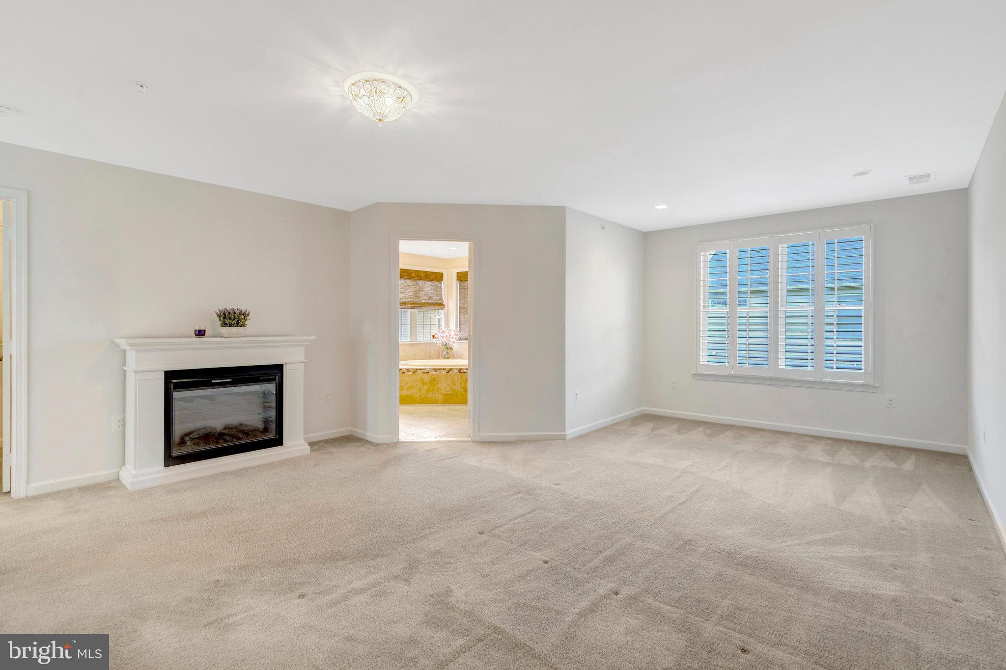 42634 Lancaster Ridge Terrace Chantilly, VA 20152 - Photo 35 of 63 an empty room with a fireplace and windows
