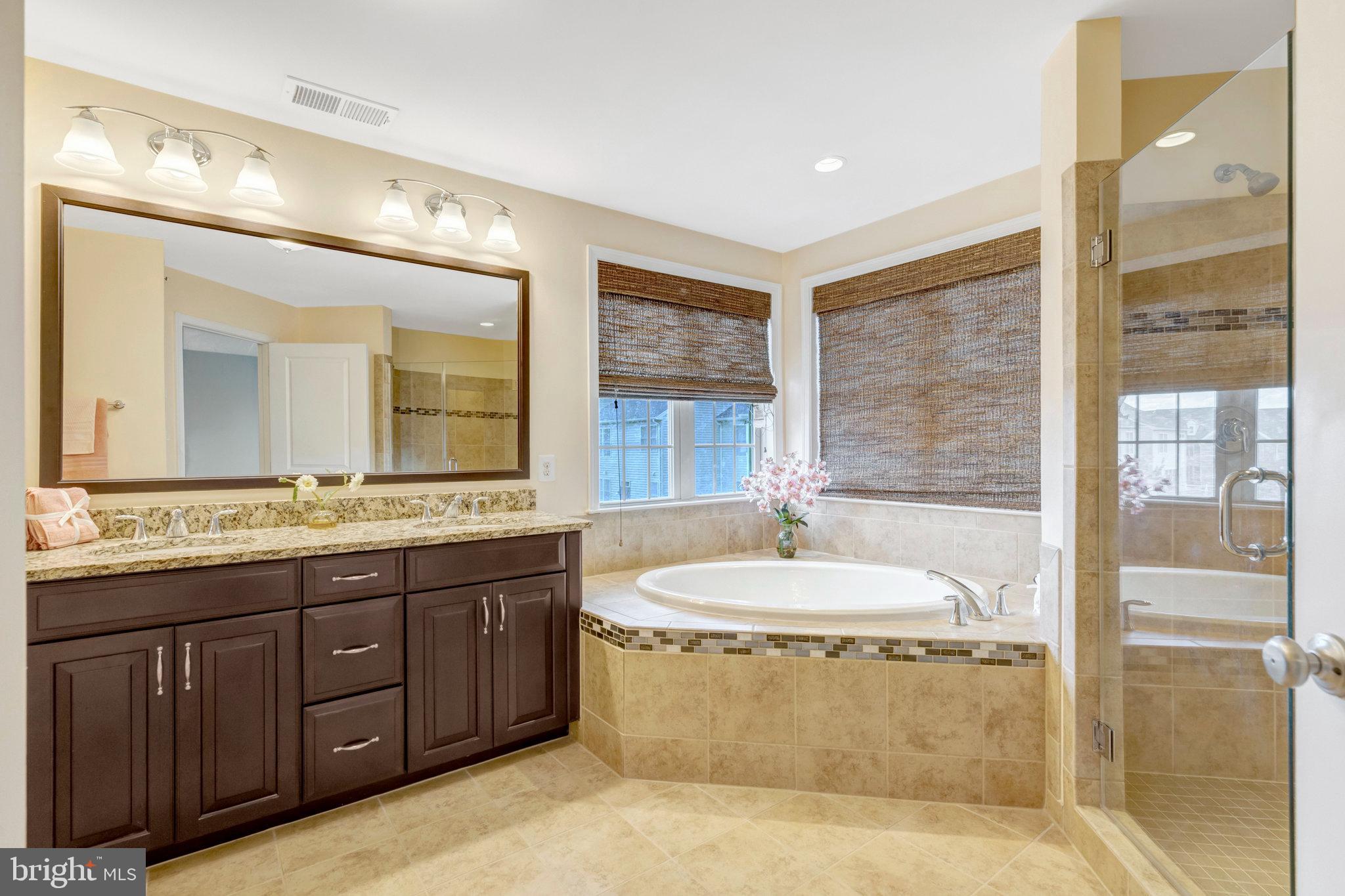 42634 Lancaster Ridge Terrace Chantilly, VA 20152 - Photo 39 of 63 a bathroom with a granite countertop sink and a mirror