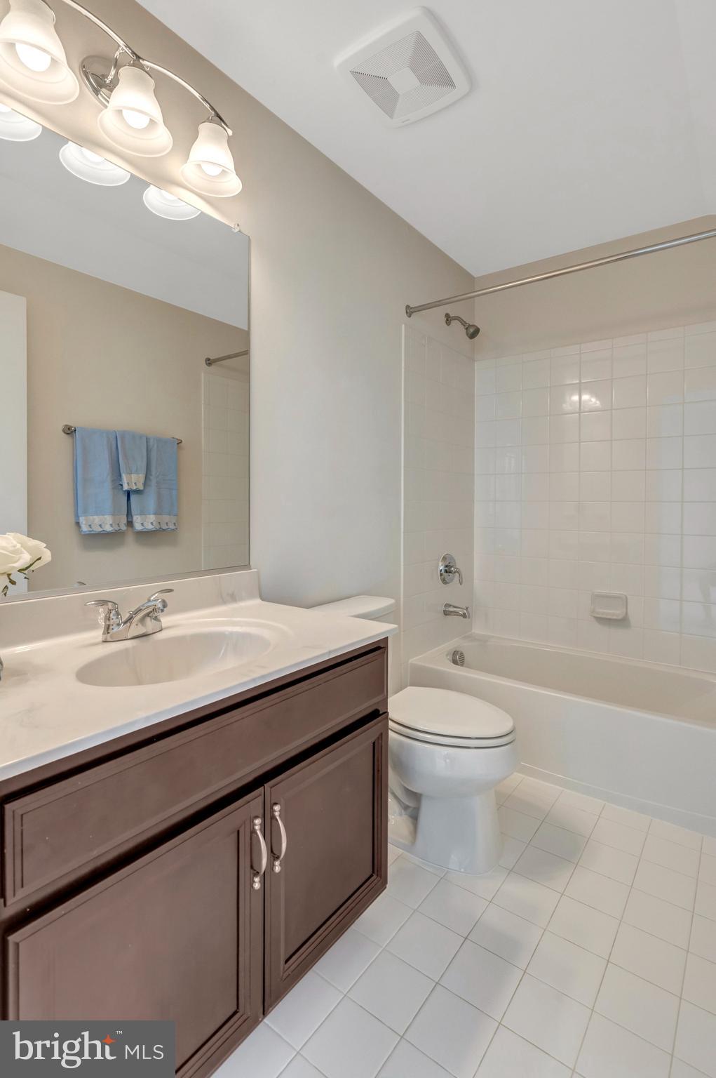 42634 Lancaster Ridge Terrace Chantilly, VA 20152 - Photo 48 of 63 a bathroom with a granite countertop toilet a sink a mirror and bathtub