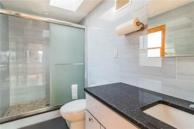 a living room with a couch and dresser with wooden floor