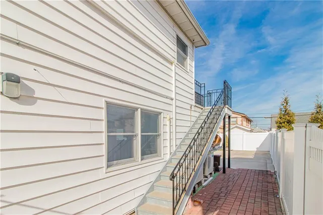 a view of staircase with white walls and railing