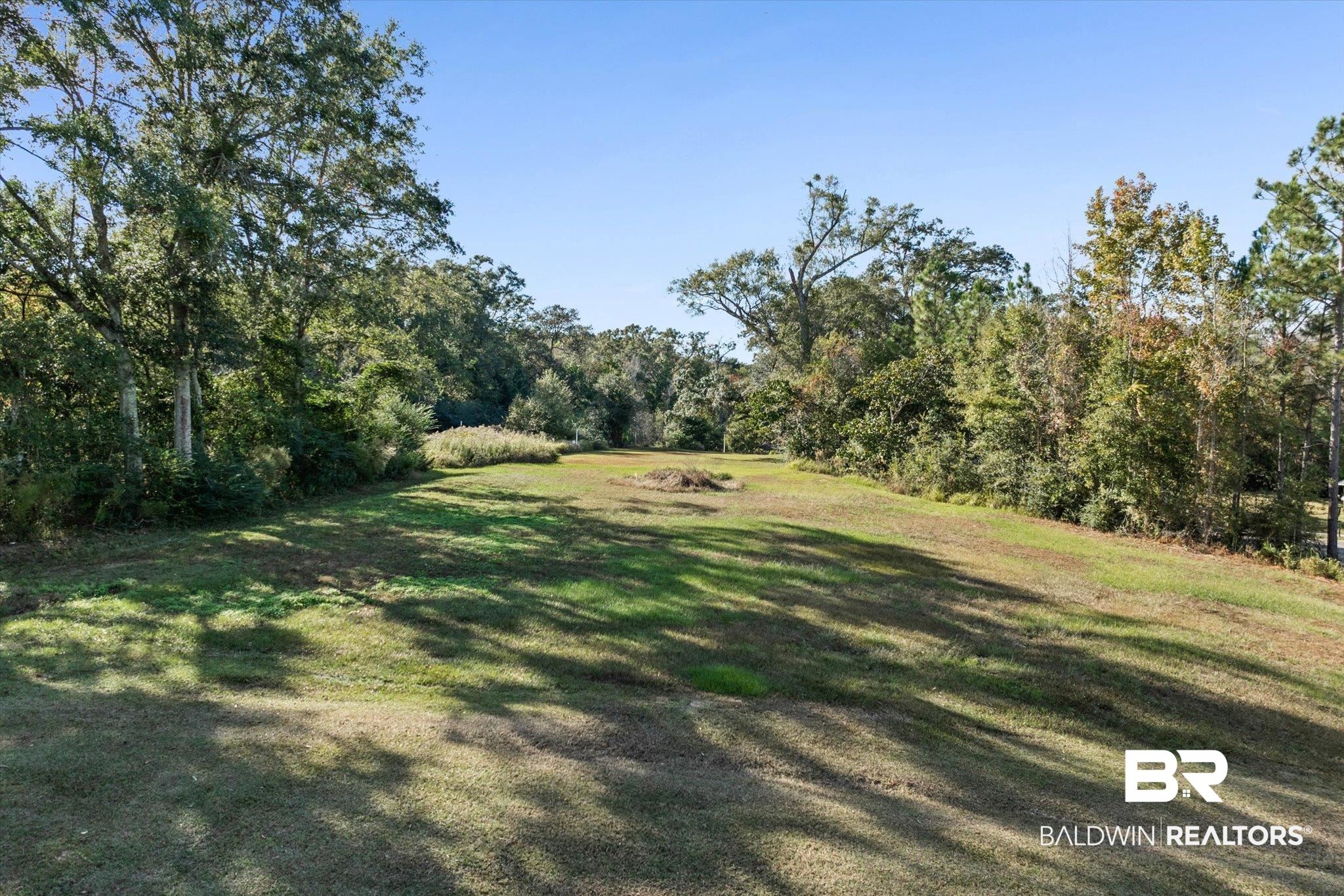 0 Acorn Way Grand Bay, AL 36541 - Photo 1 of 17 View of grassy yard with a view of trees
