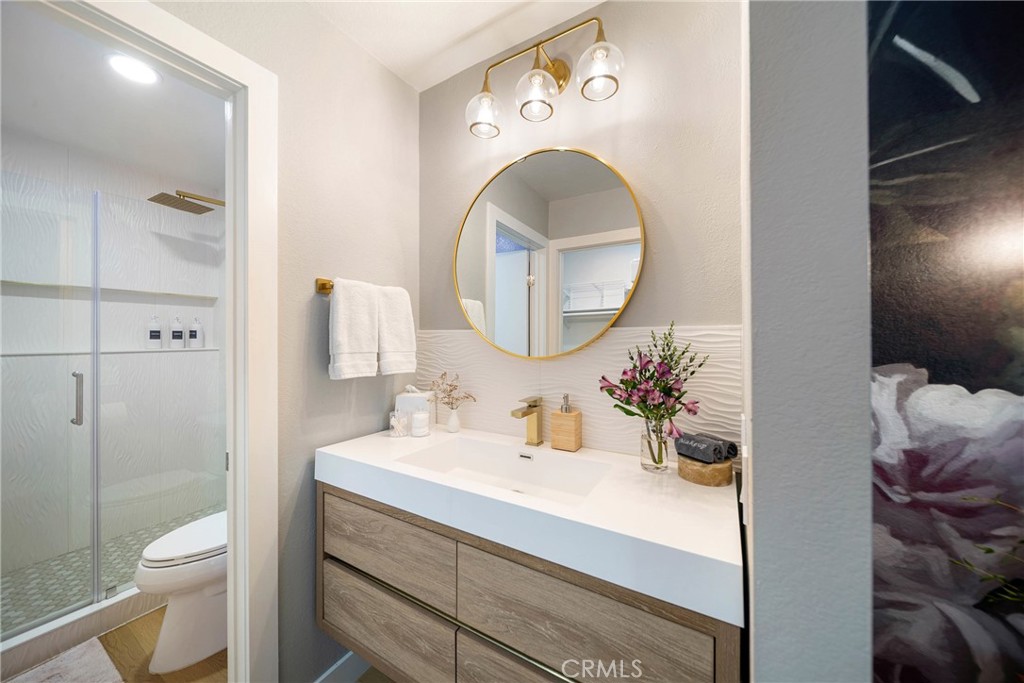 72 Corniche Drive, Unit E Dana Point, CA 92629 - Photo 11 of 61 a bathroom with a sink and a mirror