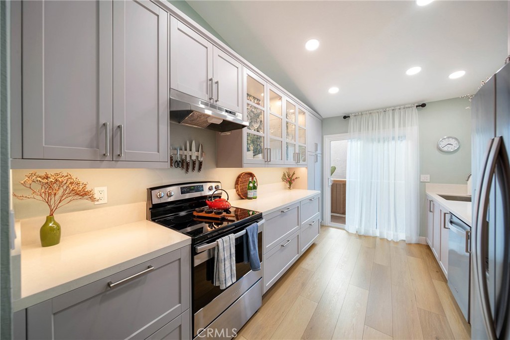 72 Corniche Drive, Unit E Dana Point, CA 92629 - Photo 2 of 61 a kitchen with stainless steel appliances a stove a sink and a refrigerator