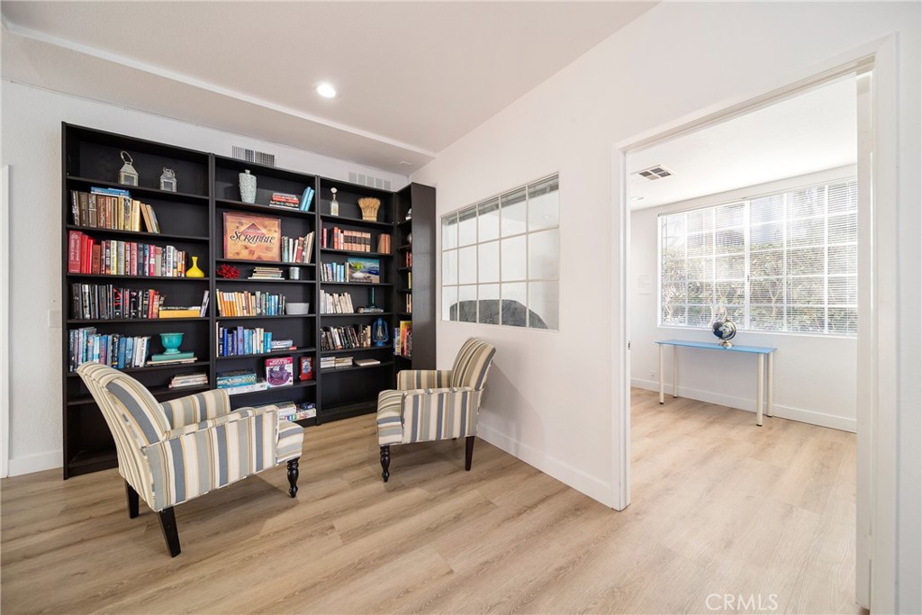 72 Corniche Drive, Unit E Dana Point, CA 92629 - Photo 40 of 61 a living room with furniture and a book shelf